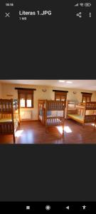 a large room with wooden benches and windows at Albergue de peregrinos Santa Marina in Molinaseca