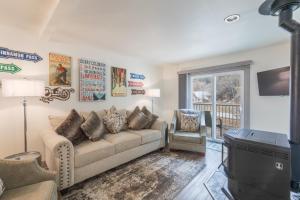 a living room with a couch and a tv at River Park 1254 in Ouray