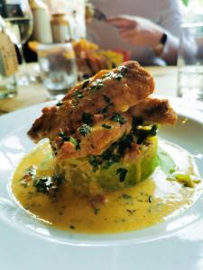 a plate of food with two pieces of chicken on top at The Rose & Crown York in York +22 photos