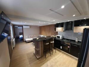 a kitchen with black cabinets and a counter top at NEAPOLIS STUDIO in Nabeul +13 photos