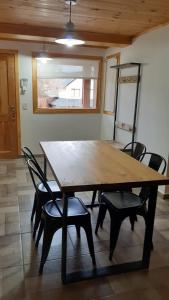 a wooden table and chairs in a room at Alihuen in San Martín de los Andes