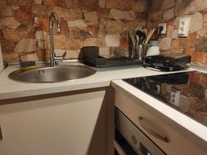 a kitchen with a sink and a counter top at Inspired by A.C. in Šibenik +45 photos