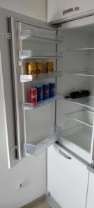 an open refrigerator with food and drinks in it at Apartman Gavric 2 in Doboj