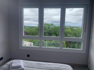a bedroom with a large window with a bed in it at lucushouse III in Lugo +9 photos