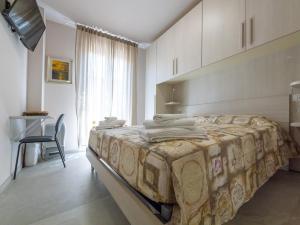 a bedroom with a large bed with towels on it at Camere Casa Azzurra in Porto San Giorgio