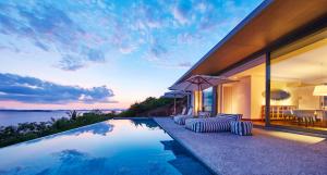 a house with a swimming pool with a view of the ocean at COMO Point Yamu, Phuket- SHA Extra Plus in Ban Pa Khlok