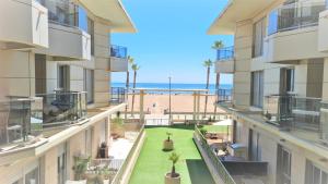 an apartment balcony with a view of the beach at Luxury Beachfront Apartment in Valencia