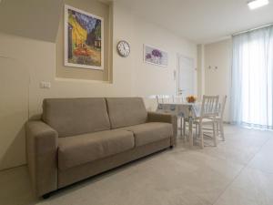 a living room with a couch and a table at Appartamento Casa Azzurra in Porto San Giorgio +11 photos