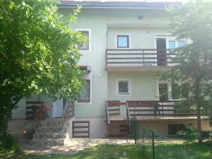 an apartment building with stairs and a balcony at Guest House Ozon in Soko Banja
