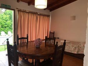 een eetkamer met een tafel en een bed bij Teilen in Villa General Belgrano