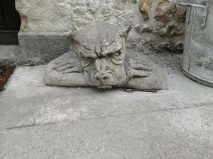 a statue of a cat sitting on the ground at Gatekeepers Cottage Tiny House, Taizé, Deux-Sevres, Velo Francette in Taizé