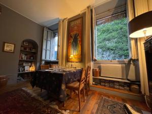 a dining room with a table and a window at La Maison in Saint-Béat