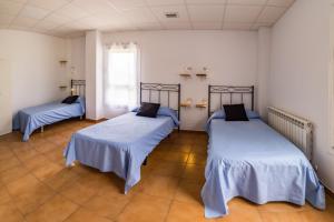 Posteľ alebo postele v izbe v ubytovaní Albergue Espiritu Xacobeo