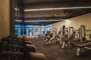 a gym with rows of tread machines at Met Hotel in La Paz