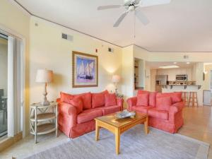 a living room with two red couches and a table at 6405 Hampton Place in Hilton Head Island