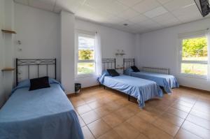 Posteľ alebo postele v izbe v ubytovaní Albergue Espiritu Xacobeo