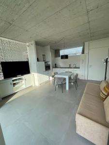 a large white living room with a table and chairs at Guendalina Suite 2 in Verona +4 photos