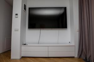 a flat screen tv on a white wall at Novum Aparthotel in Bucharest