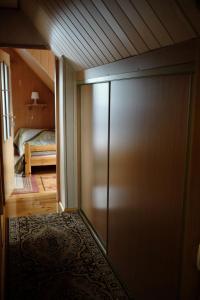 a sliding door leading to a bedroom with a bed at U Heleny i Piotra pokoje goscinne in Białowieża