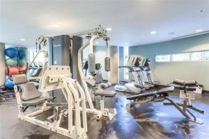 a gym with several tread machines in a room at Vancouver Downtown Accommodation in Vancouver