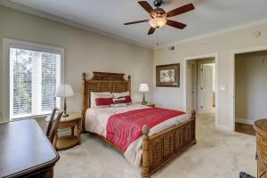 a bedroom with a bed and a ceiling fan at 407 Main Sail in Hilton Head Island +62 photos