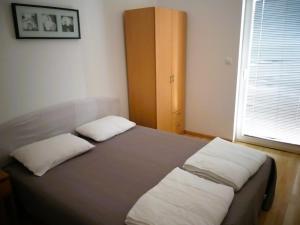 Łóżko lub łóżka w pokoju w obiekcie Villa Dobra Family Apartments