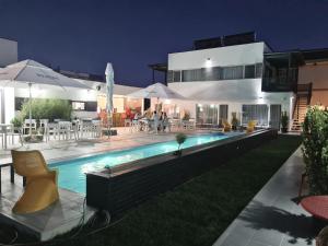 a villa with a swimming pool at night at Bunga Bunga Resort Mamaia Nord in Mamaia Sat/Năvodari