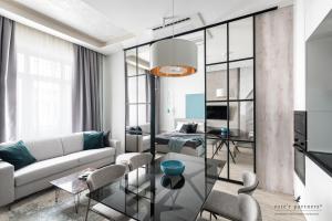 a living room with a couch and a table at White Boat Apartment BLUE in Budapest