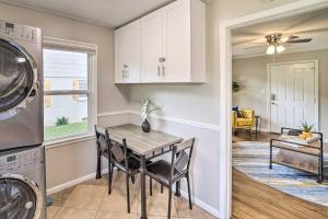 a kitchen and dining room with a table and a washing machine at Adorable Tulsa Home Less Than 2 Mi to Expo Center! in Tulsa