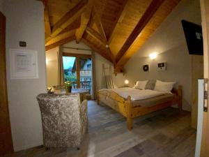a bedroom with a bed and a large window at Megusta in Weissensee