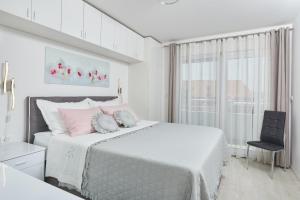 מיטה או מיטות בחדר ב-Apartments Infinity