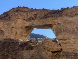 an arch in the side of a cliff at Cuevas el Torriblanco in Gorafe