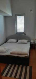 Łóżko lub łóżka w pokoju w obiekcie Villa Dobra Family Apartments