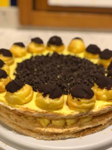 a cake with chocolate on top on a plate at B&B Il Tabià in Pieve di Cadore