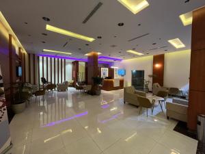 a lobby with chairs and tables in a building at هاوس إن House Inn in Najran