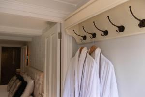 a bathroom with white towels hanging on a wall at Guesthouse "Mirabelle" met indoor jacuzzi, sauna & airco in Tilburg