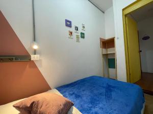 a bedroom with a blue bed and a blue wall at Hostal Macondo Bogotá in Bogotá