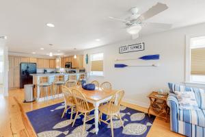 a kitchen and living room with a table and chairs at No Bad Dayz NH121 in Nags Head