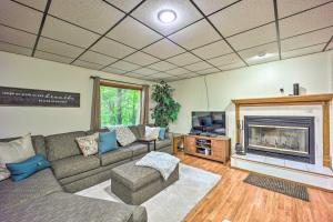 a living room with a couch and a fireplace at Waterfront Home on Beaver Lake with 2 Decks! in Garfield