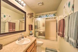 a bathroom with a sink and a toilet and a shower at Waterfront Home on Beaver Lake with 2 Decks! in Garfield +35 photos