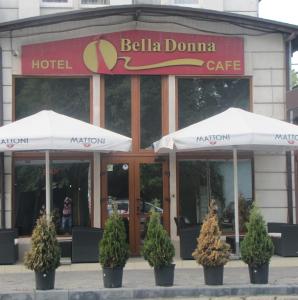 a hotel with umbrellas in front of a building at Bella Donna Hotel in Chişinău