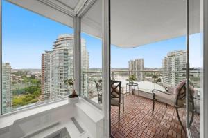 a balcony with a view of a city with tall buildings at Water View Condo in Downtown Vancouver (2BR/2Bath) in Vancouver