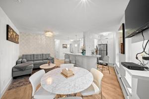 a living room and kitchen with a table and chairs at Water View Condo in Downtown Vancouver (2BR/2Bath) in Vancouver