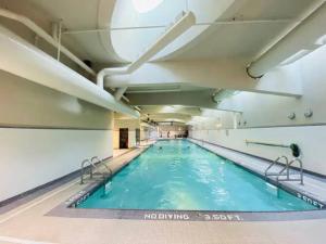 a large indoor swimming pool with blue water at Water View Condo in Downtown Vancouver (2BR/2Bath) in Vancouver