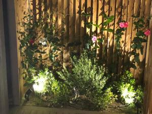 a fence with flowers and plants in front of it at La Verda in Bonifacio