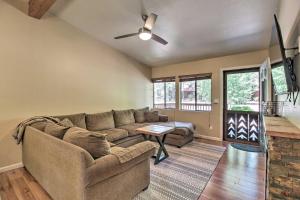 a living room with a couch and a table at Patio, Fenced Yard Pet-Friendly Pinetop Cabin! in Indian Pine