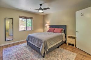 a bedroom with a bed and a ceiling fan at Patio, Fenced Yard Pet-Friendly Pinetop Cabin! in Indian Pine