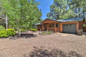 a house with a garage and a driveway at Patio, Fenced Yard Pet-Friendly Pinetop Cabin! in Indian Pine
