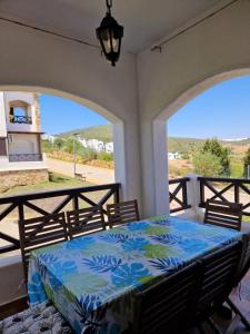 a bedroom with a bed on a balcony at Bel appartement 3chambres Lilac's Garden Cabo Negro in Cabo Negro