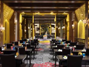 a dining room with tables and chairs and a lobby at Hotel Indigo Bali Seminyak Beach by IHG in Seminyak